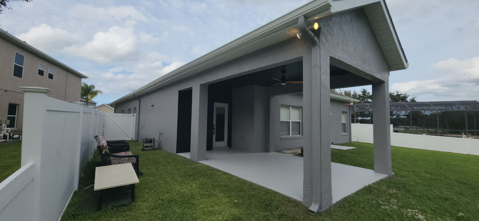 A house with a covered patio in the backyard.