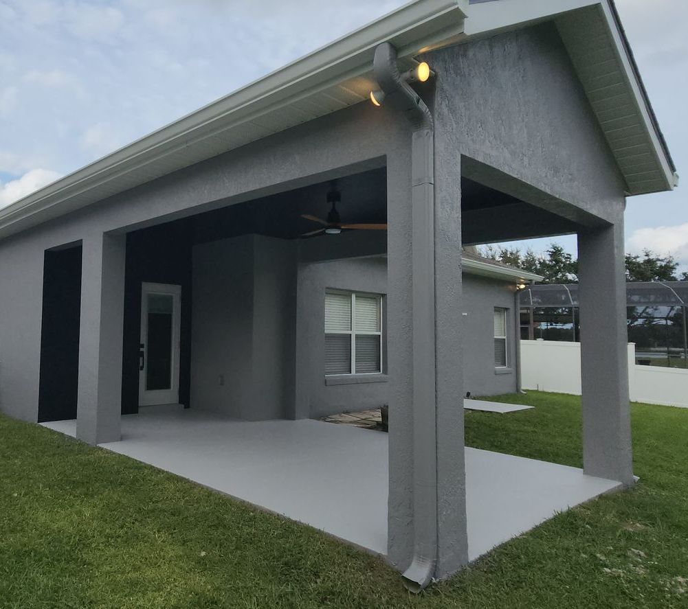 A house with solar panels on the roof is being painted.